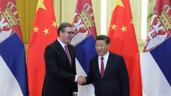 Serbia's President Aleksandar Vucic shakes hands with China's President Xi Jinping