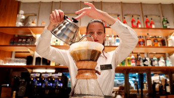 An employee prepares a coffee inside the new Starbucks Reserve Roastery flagship