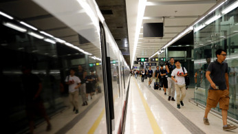 Passengers walk inside West Kowloon Terminus on the first day of service of the Hong Kong Section of the Guangzhou-Shenzhen-Hong Kong Express Rail Link