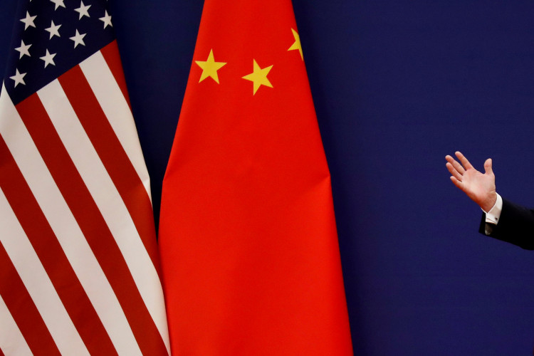 U.S. President Donald Trump delivers his speech next to U.S. and Chinese flags in Beijing