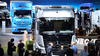Visitors surround an Actros truck of German truck maker Mercedes-Benz at the IAA truck trade fair in Hanover