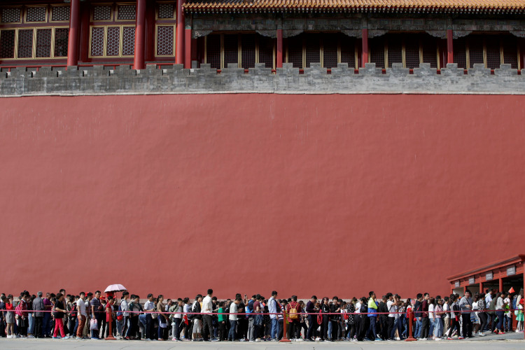 Tourists wait to visit the Forbidden City in central Beijing, China