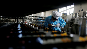 Labourer works inside an electronics factory