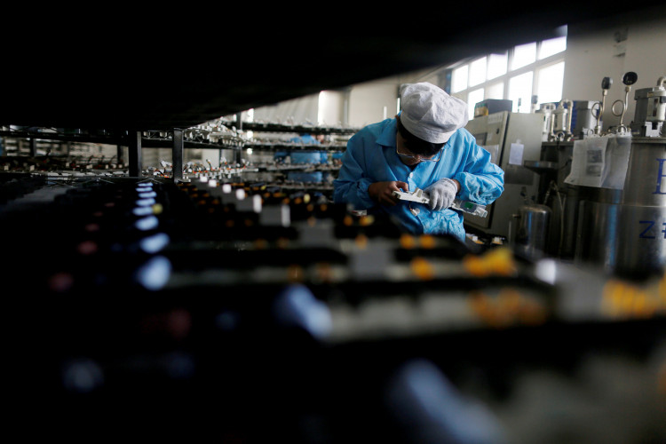 Labourer works inside an electronics factory