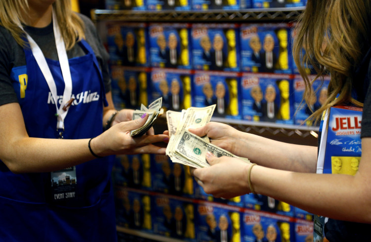 Workers at the Kraft Heinz booth count money at the shareholder shopping day 