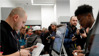 An employee works during the launch of the new iPhone XS and XS Max sales at a shop in Moscow