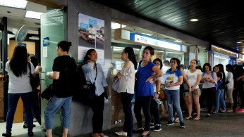 Domestic helpers line up for remittance services