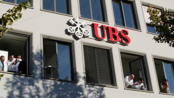Employees of Swiss bank UBS take pictures as actor Depp leaves during the 14th Zurich Film Festival in Zurich
