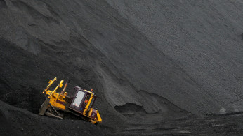 A labourer operates a bulldozer on a stockpile of coal at Vorgashorskaya mine outside the far northern city of Vorkuta