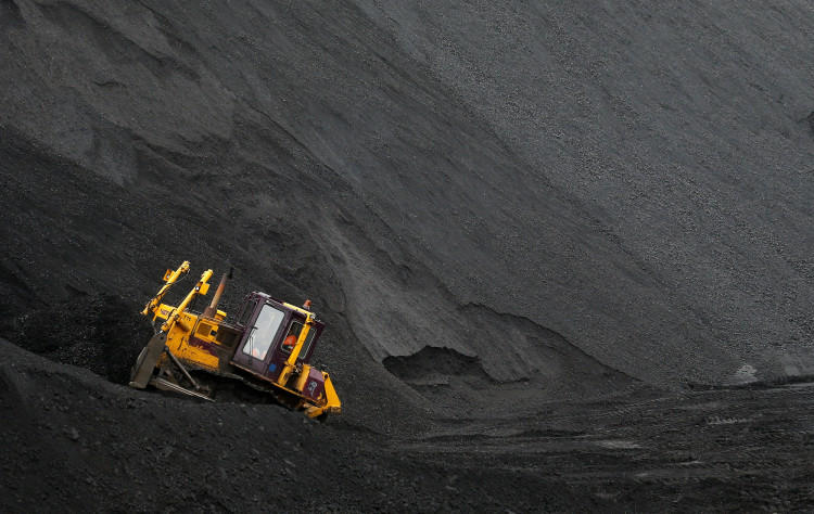 A labourer operates a bulldozer on a stockpile of coal at Vorgashorskaya mine outside the far northern city of Vorkuta