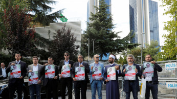 Demonstrators hold pictures of Saudi journalist Jamal Khashoggi 