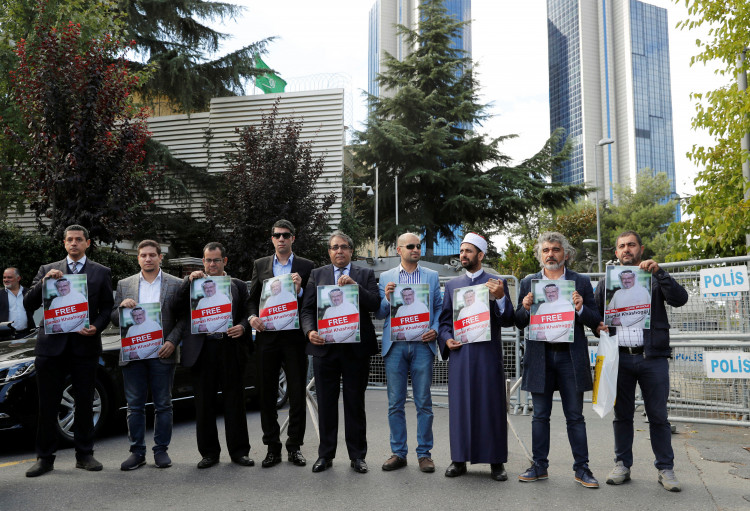 Demonstrators hold pictures of Saudi journalist Jamal Khashoggi 