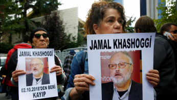 Activists hold pictures of Saudi journalist Jamal Khashoggi during a protest 