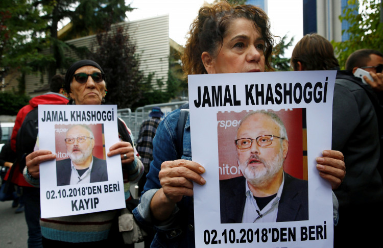 Activists hold pictures of Saudi journalist Jamal Khashoggi during a protest 