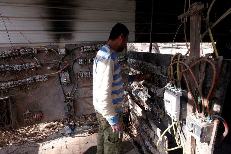 An electrician works at a local generator in Baghdad