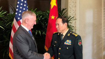 U.S. Defense Secretary Jim Mattis and China's Defense Minister Wei Fenghe greet each other ahead of talks in Singapore