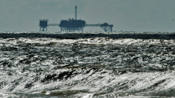 An oil and gas drilling platform stands offshore in the Gulf of Mexico 
