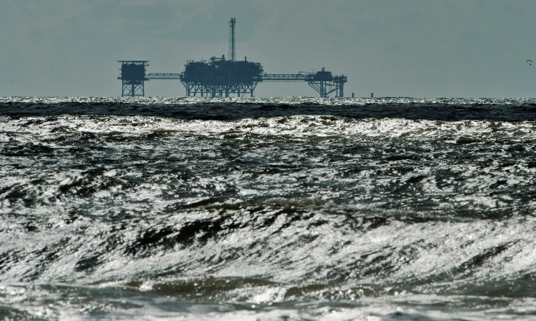 An oil and gas drilling platform stands offshore in the Gulf of Mexico 