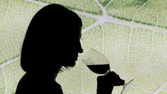 A woman tastes red wine in the cellar of Chateau Smith Haut Lafitte (Graves Pessac Leognan label) in Martillac, France, October 23, 2018. 