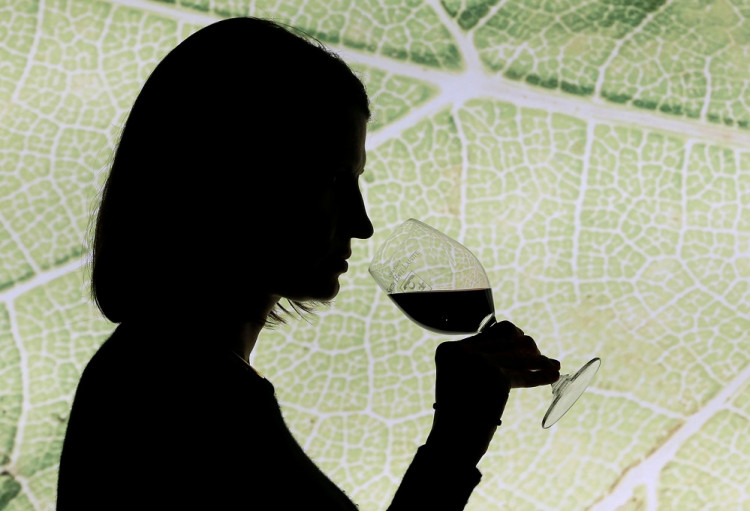 A woman tastes red wine in the cellar of Chateau Smith Haut Lafitte (Graves Pessac Leognan label) in Martillac, France, October 23, 2018. 