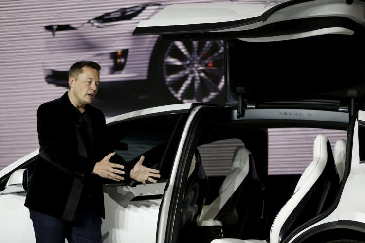 Tesla Motors CEO Elon Musk introduces the falcon wing door on the Model X electric sports-utility vehicles during a presentation in Fremont