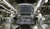 Mazda Motor Corp work on the assembly line 