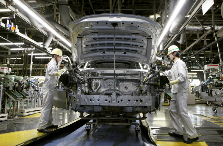 Mazda Motor Corp work on the assembly line 