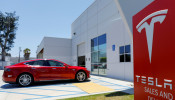 A Tesla sales and service center is shown in Costa Mesa, California