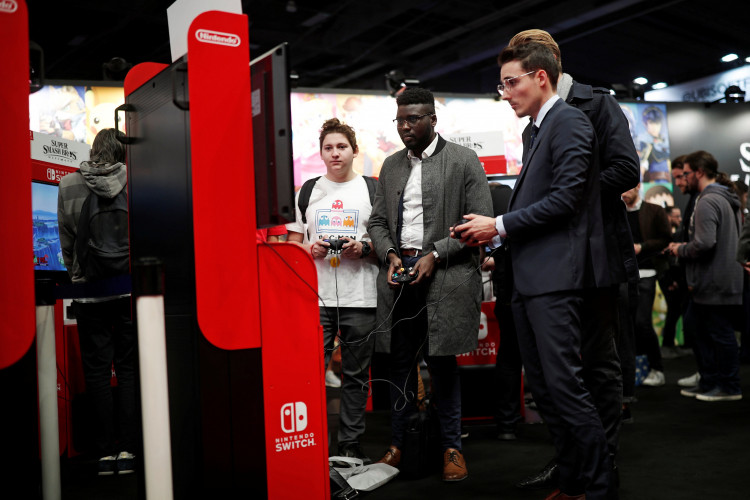 Visitors play Super Smash Bros Ultimate on Nintendo Switch at the Paris Games Week (PGW), a trade fair for video games in Paris