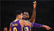 Los Angeles Lakers forward LeBron James (23) talks to Los Angeles Lakers forward Kyle Kuzma (0) 
