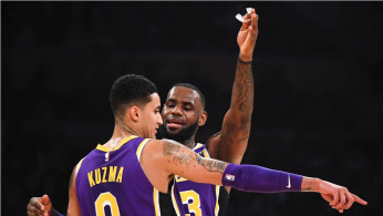Los Angeles Lakers forward LeBron James (23) talks to Los Angeles Lakers forward Kyle Kuzma (0) 