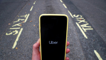 The Uber application is seen on a mobile phone in London