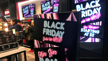 A Black Friday sale sign is displayed outside a makeup store at Roosevelt Field shopping mall in Garden City
