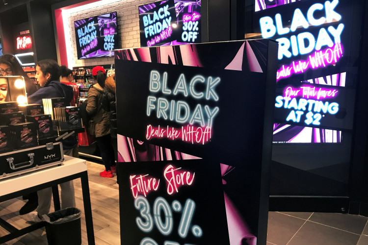 A Black Friday sale sign is displayed outside a makeup store at Roosevelt Field shopping mall in Garden City