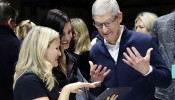 Apple CEO Tim Cook tries out the new iPad Pro as singer Lana Del Rey (middle) looks on during an Apple launch event in the Brooklyn borough of New York