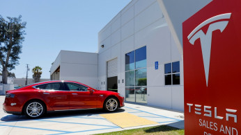 A Tesla sales and service center is shown in Costa Mesa, California