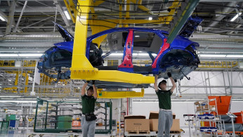 Employees work at the production line inside the Chery Jaguar Land Rover plant phase 2 after the phase 2 opening ceremony in Changshu