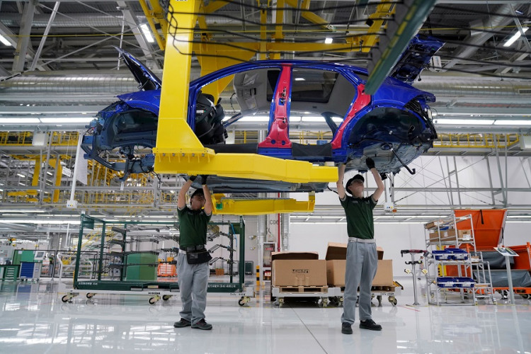 Employees work at the production line inside the Chery Jaguar Land Rover plant phase 2 after the phase 2 opening ceremony in Changshu