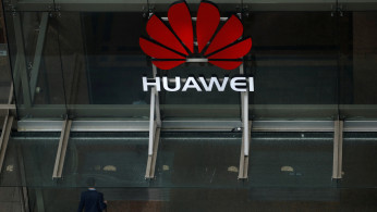 A man walks into the offices of telecommunications company Huawei in Auckland