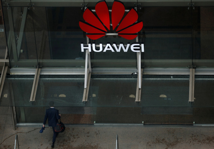 A man walks into the offices of telecommunications company Huawei in Auckland