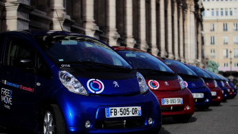 Free2Move Paris electric vehicles by Groupe PSA are displayed outside Paris city hall as the French car maker launches its free-floating car-sharing service in Paris