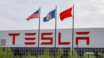 Flags fly over the Tesla Inc. Gigafactory 2, which is also known as RiverBend, a joint venture with Panasonic to produce solar panels and roof tiles in Buffalo, New York