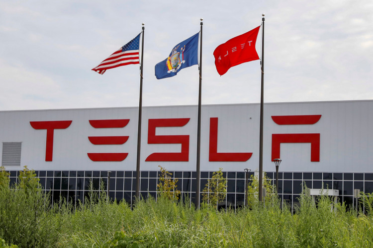 Flags fly over the Tesla Inc. Gigafactory 2, which is also known as RiverBend, a joint venture with Panasonic to produce solar panels and roof tiles in Buffalo, New York