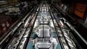 Employees work on an assembly line of the Toyota Motor Corp's Prius hybrid car at the Tsutsumi plant in Toyota
