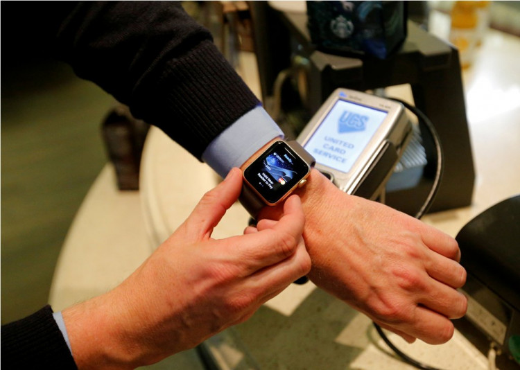 A man uses an Apple Watch to demonstrate the mobile payment service Apple Pay at a cafe in Moscow, Russia, October 3, 2016. 
