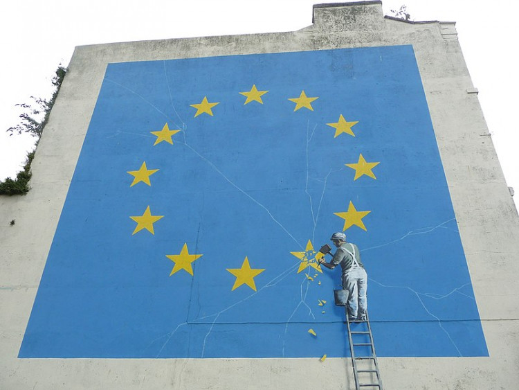 Banksy Brexit mural of man chipping away at EU flag 