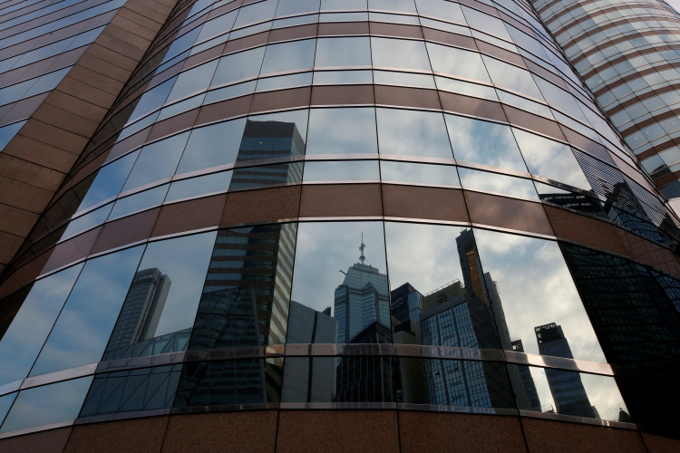 Nearby buildings are reflected on the exterior of a commercial tower at the financial Central district in Hong Kong