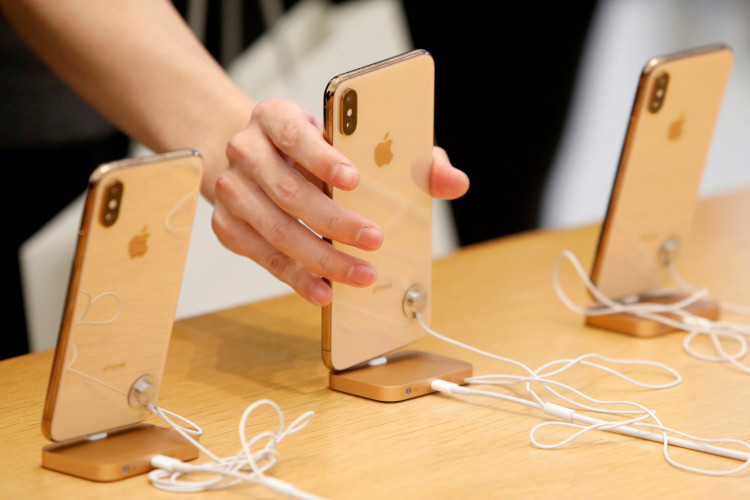 People look at iPhones at the World Trade Center Apple Store during a Black Friday sales event in Manhattan, New York City