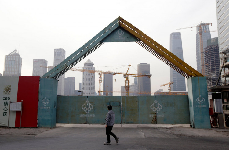 A man walks outside the construction sites in Beijing's central business area