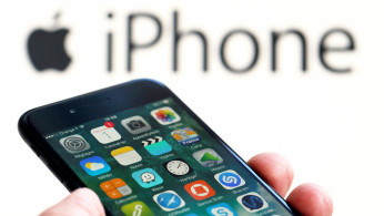 An Apple iPhone 7 and the company logo are seen in this illustration picture taken in Bordeaux
